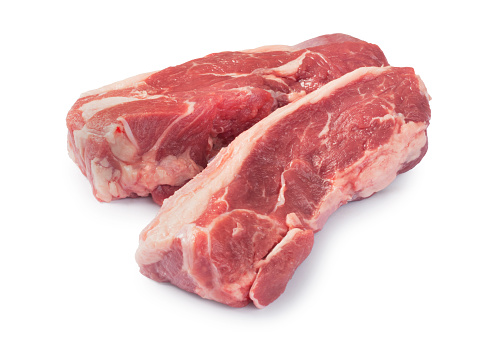 Studio shot of raw rump of lamb steaks cut out against a white background