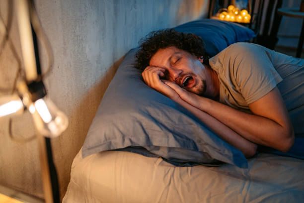 istock Young Man Snoring In The Bed At Night 1693544758
