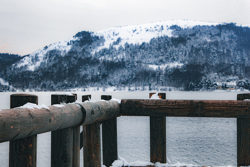 Snowy mountain landscape and lake pier
