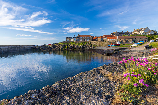 The small fishing village of Craster, with its picturesque harbour, on the coast of Northumberland.
