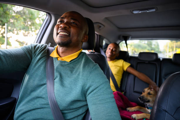 istock Proud father driving looking at son in review mirror 1693568877