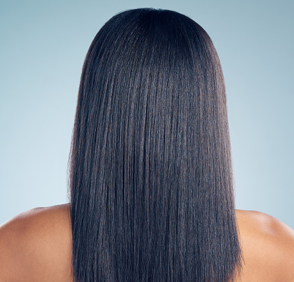 Beauty, hair and shampoo with a woman from the back in studio on a gray background for salon treatment. Luxury, spa or keratin for haircare and a model closeup with natural and aesthetic growth