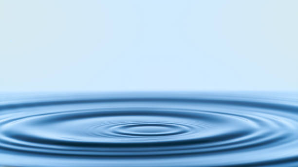 istock Group of water droplets fall and bounce on a water surface 1693570125