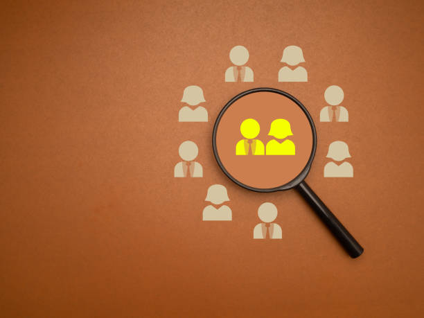 istock A magnifying glass with people icons on a brown background 1693585531