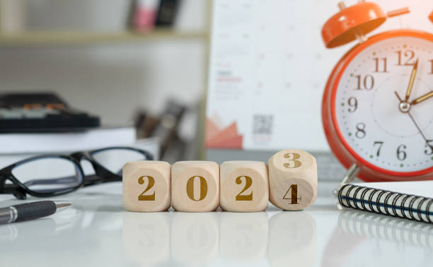istock 2024 new year idea concept. 2024 text on wooden blocks with data analysis and office concept background. Budgeting concept. 1693586148