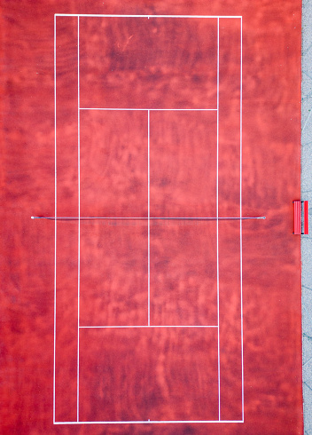 Top down aerial view of an empty bright tennis court, waiting for a game, no people