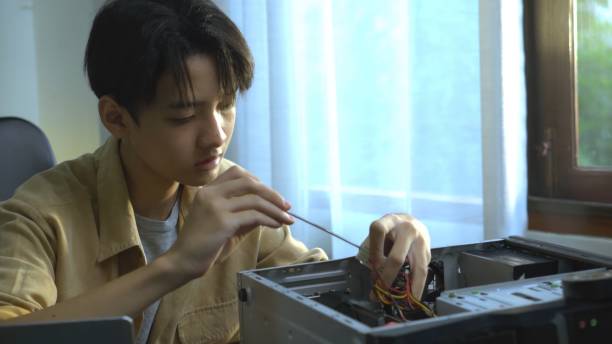 istock Asian young boy learning to repair computer and electronic board in the classroom.  Engineering electronic education in colleges. 1693619337