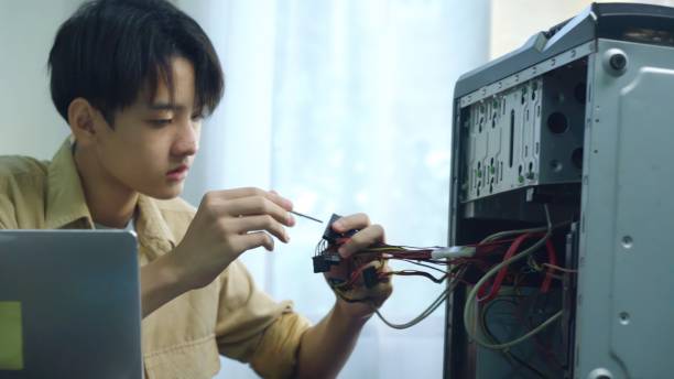 istock Asian young boy learning to repair computer and electronic board in the classroom.  Engineering electronic education in colleges. 1693619892