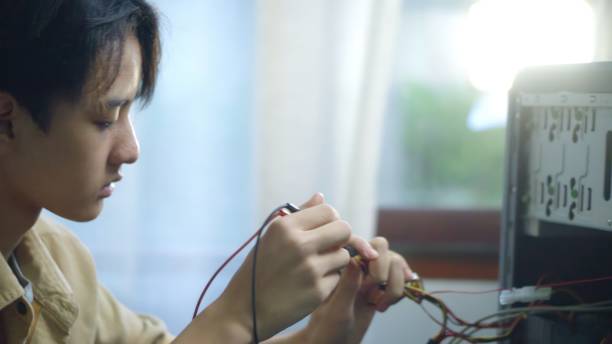 istock Asian students using measurements repairing electronic pc hardware in the classroom. 1693621250