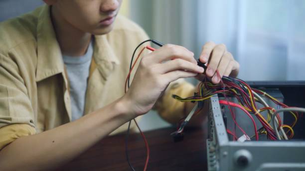 istock Asian students using measurements repairing electronic pc hardware in the classroom. 1693621810
