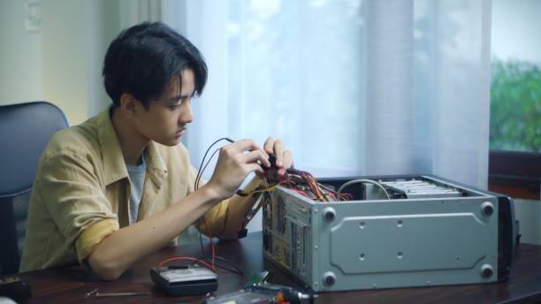 istock Asian students using measurements repairing electronic pc hardware in the classroom. 1693622506