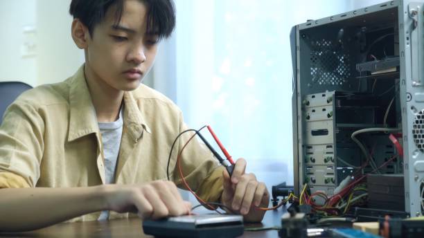 istock Asian students using measurements repairing electronic pc hardware in the classroom. 1693624009