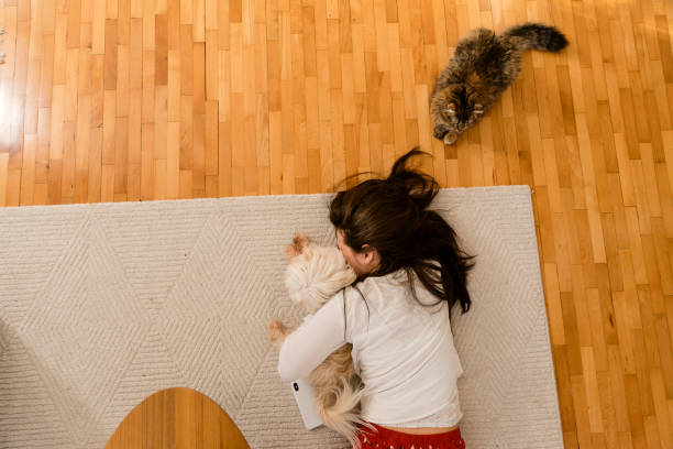 istock Girls lying on the floor and playing with her pets 1693626513