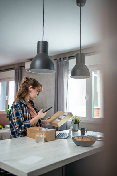 istock A young woman is checking a package at home that has just arrived for her, which she ordered online 1693633413