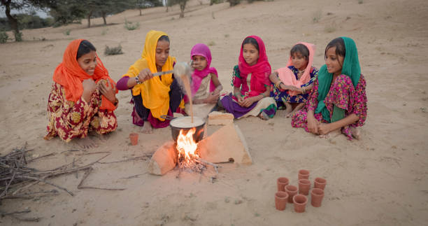 istock Indian children preparing chai - masala tea 1693644875