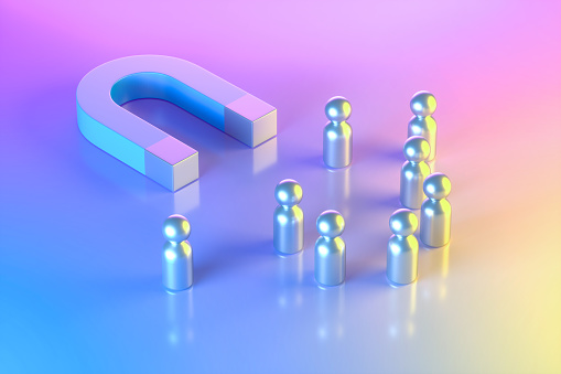 Magnet with Group of Pawn People on Neon Lighting Background, Blue Pink Yellow Colors. Digitally generated image.