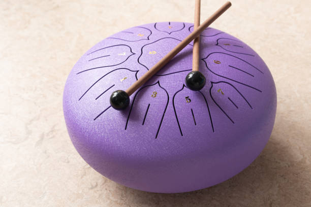 istock Tongue drum with drumsticks, Purple hang drum 1693646604