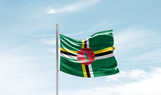 Dominica national waving flag in the sky.