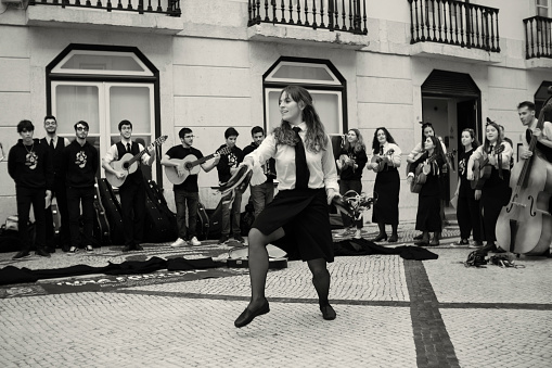 Lisbon, Portugal - October 29, 2022: A group of college students perform at the Rua Augusta street in Lisbon downtown.