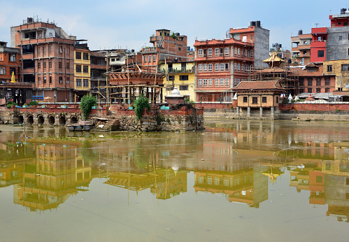 Lalitpur / Patan, Nepal: buildings reflected on the Pimbahal Pond (aka Pimbahaa Pukhoo or Pim Bahal Pokhari), Krishna Temple in the center and medieval pagoda temple of Candesvari to its right.