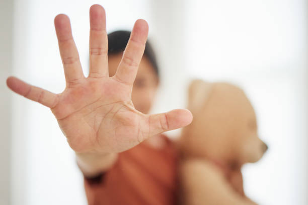 istock Hand, child and palm with stop for violence, abuse and warning sign in support for harassment and protection. Person, kid and no gesture for protest, fight or defence expression with empowerment 1693666545