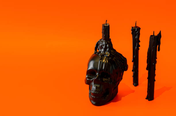 Black skull and candles put on orange background. Halloween party concept.