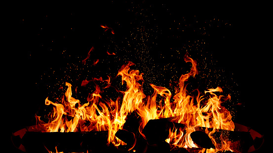 Blazing campfire isolated black background