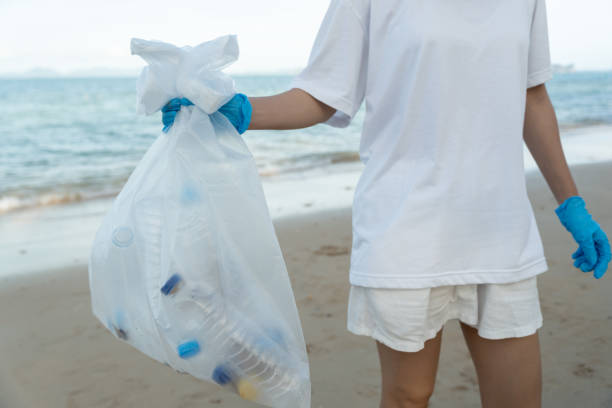 istock Save ocean. Volunteer pick up trash garbage at the beach and plastic bottles are difficult decompose prevent harm aquatic life. Earth, Environment, Greening planet, reduce global warming, Save world 1693696697
