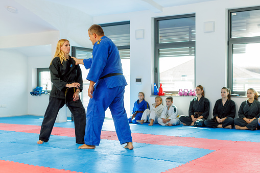 Two masters of real aikido talk to children during training.