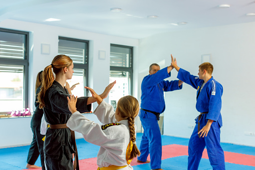Real aikido sensei working with children on training.