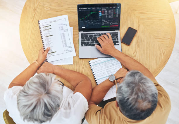 istock Couple, computer screen and data analysis, stock market graphs and budget, financial planning or asset management above. Senior people on laptop for trading, investment and accounting report or stats 1693714845