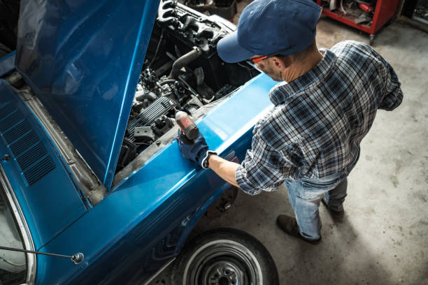 istock Car Mechanic Performing Classic Car Engine Repairs 1693717641