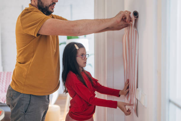istock Father and daughter choosing new wallpapers for their home 1693721370