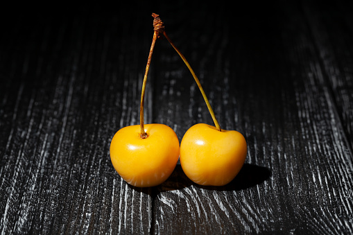 yellow cherry on wood background