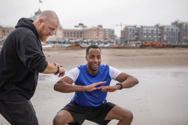 A handsome black male and personal trainer working out on the beach to get ready for the dating world
