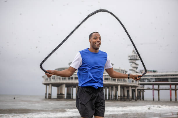 A handsome black male working out on the beach to get ready for the dating world