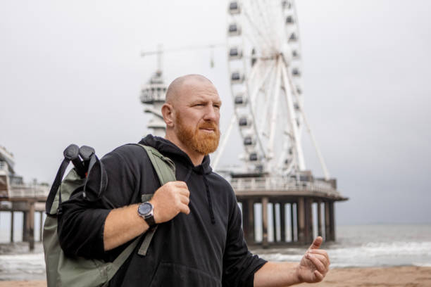 A handsome redhead male working out on the beach to get ready for the dating world