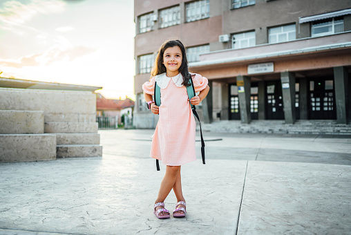 Portrait of smiling girl in front of the school building