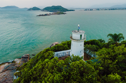 Aerial view of scenic coastline with lighthouse in Santa Catarina, Brazil