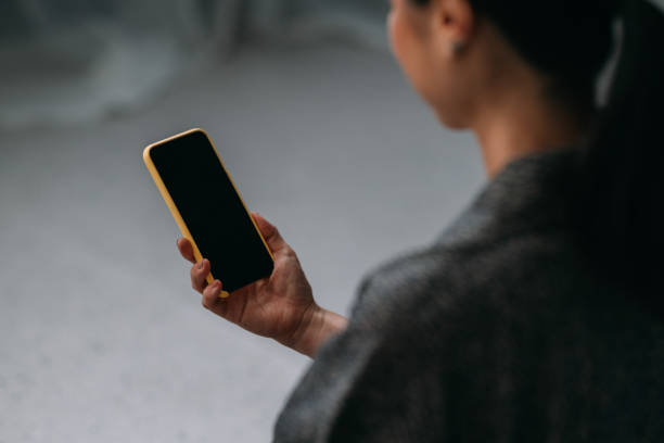 istock Japanese Woman in a Kimono Using a Mobile Phone 1693747291