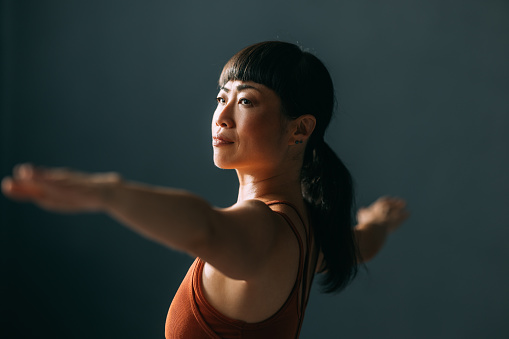 Asian Woman in a Yoga Class