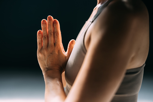 Namaste: hands of an anonymous woman meditating.