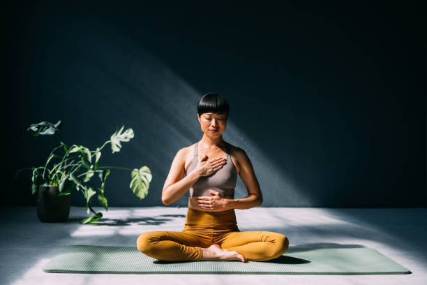 Japanese Woman Finding Serenity: Yoga for Mental Wellness stock photo