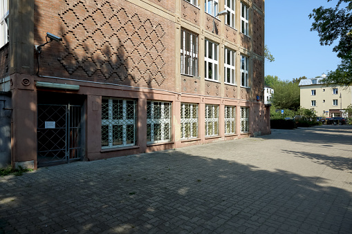 Warsaw, Poland - September 13, 2023: A building with a brick facade in the Saska Kepa housing estate in the Praga-Poludnie district. It houses the High School, named after Boleslaw Prus.