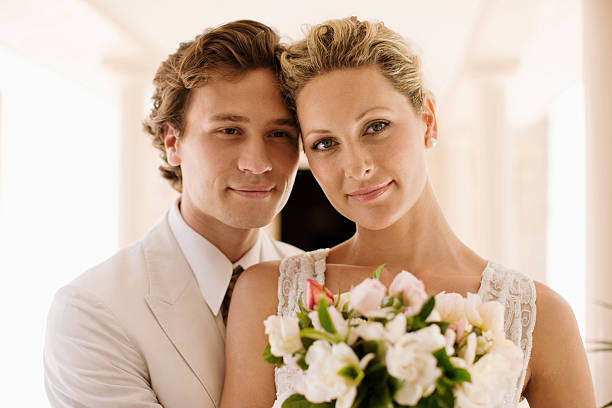 istock Bride and groom smelling bouquet 169376969