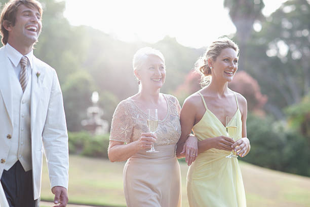 Wedding guests walking across lawn  guest stock pictures, royalty-free photos & images