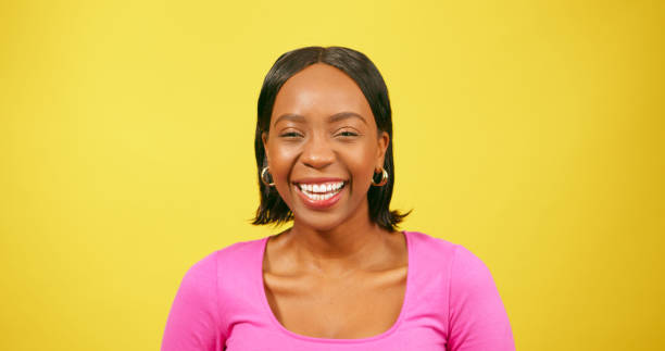 istock Laughing young woman, Black beautiful, yellow background studio 1693775960