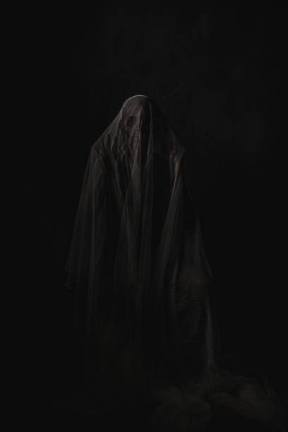 istock Creepy ghost in a dark room. Halloween concept image. 1693777165