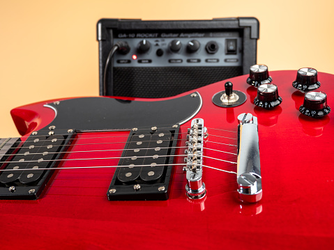 Red six-string electric guitar. Electric guitar close-up.