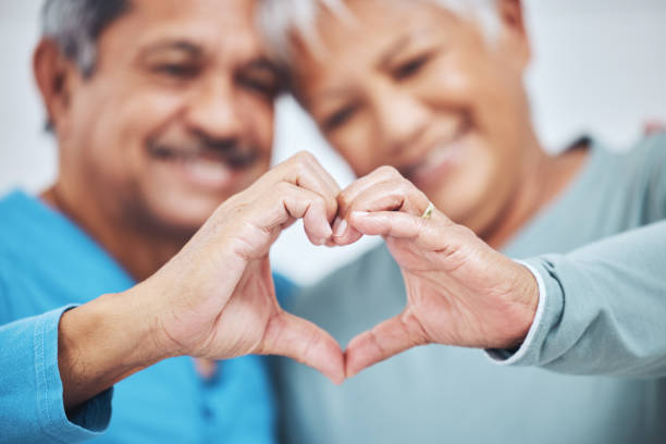 istock Heart, mature couple and hands for care in healthy relationship, connection or commitment to marriage. Love sign, romance of man and woman in loyalty, kindness or emoji to support in trust together 1693783273